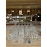 A QUANTITY OF GLASSES TO INCLUDE CHAMPAGNE FLUTES, TUMBLERS, BRANDY, SHERRY, ETC