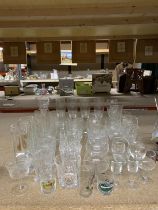 A QUANTITY OF GLASSES TO INCLUDE CHAMPAGNE FLUTES, TUMBLERS, BRANDY, SHERRY, ETC