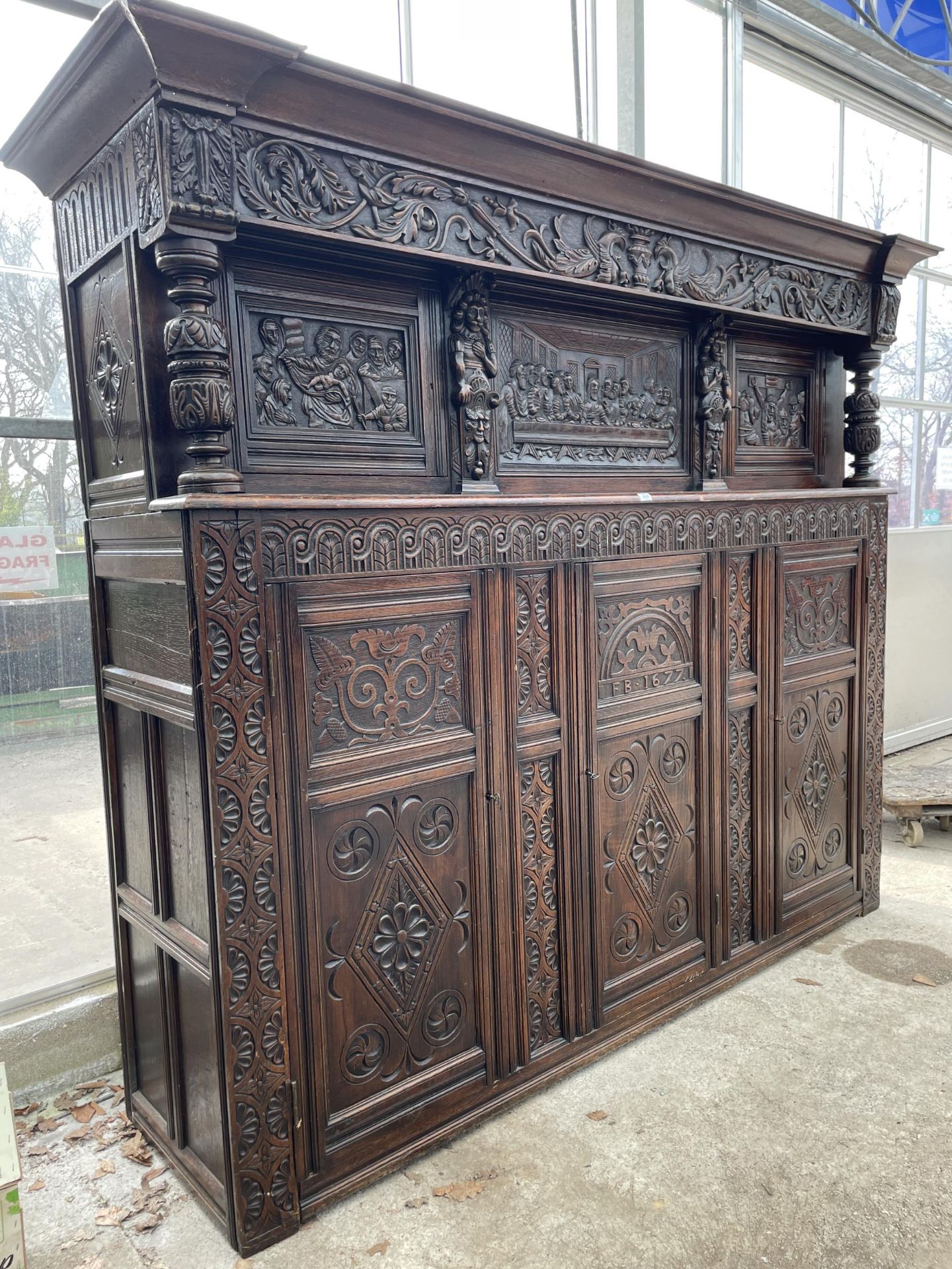 AN OAK GEORGE III STYLE COURT CUPBOARD WITH CARVED PANELS, THREE DEPICTING THE BIRTH AND CRUCIFIXION - Image 4 of 12