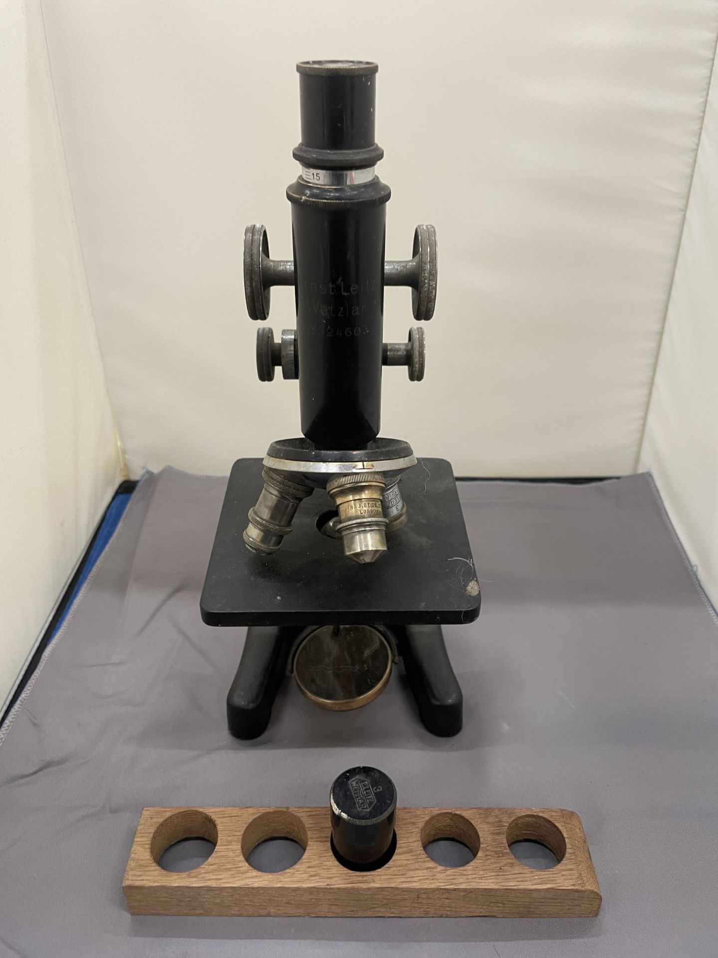 AN ERNST LEITZ WETZLAR MICROSCOPE, NO. 324603, WITH WOOD TRAY AND SPARE LENS