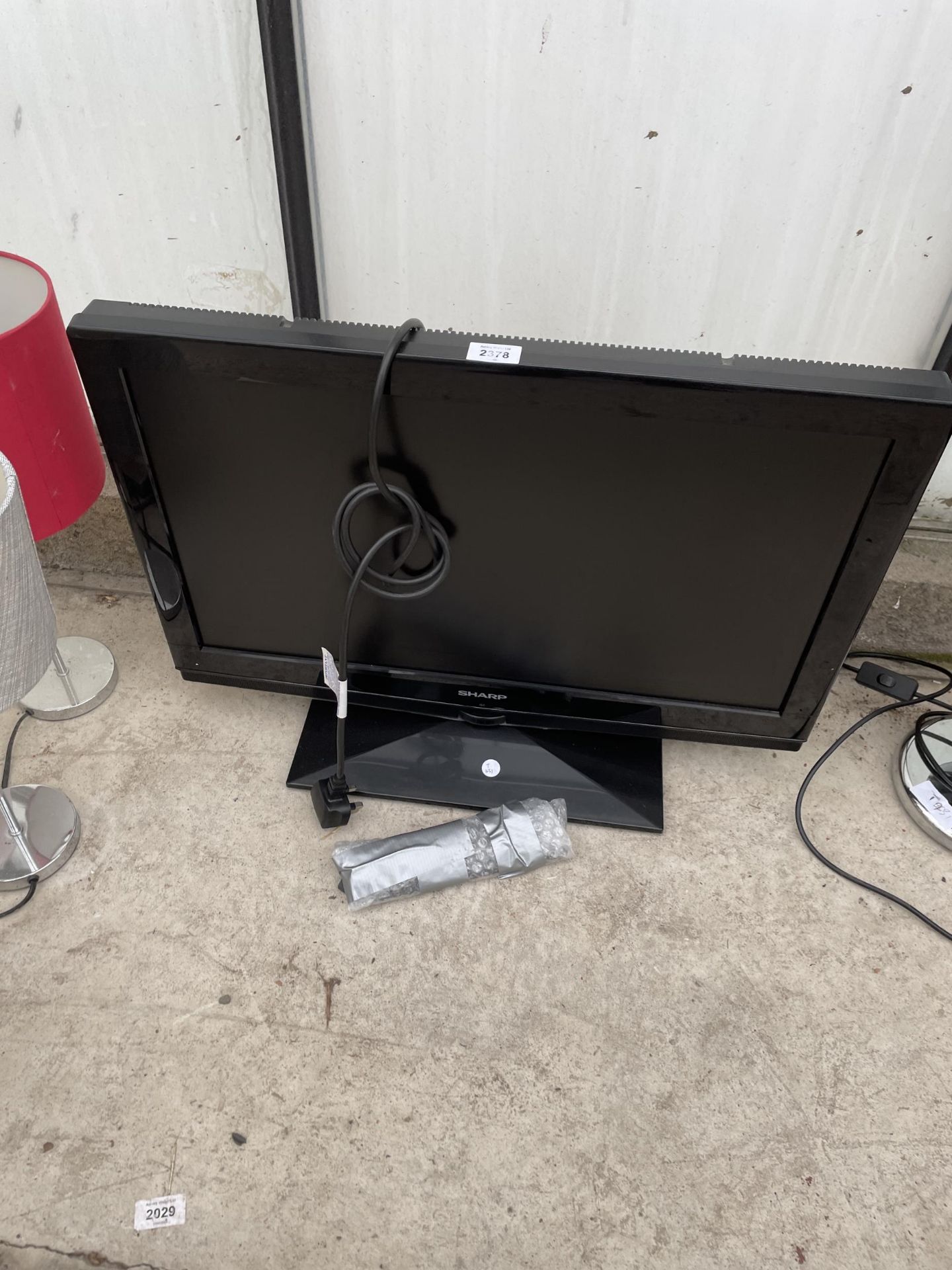 A SHARP 26" TELEVISION WITH REMOTE CONTROL