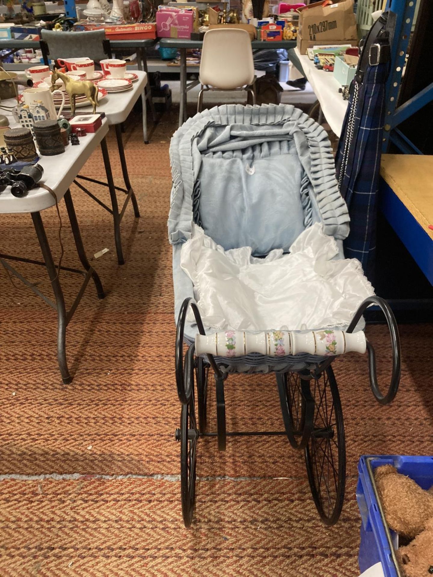 A LARGE VINTAGE PRAM WITH CERAMIC HANDLE AND DECORATION TO THE SIDE