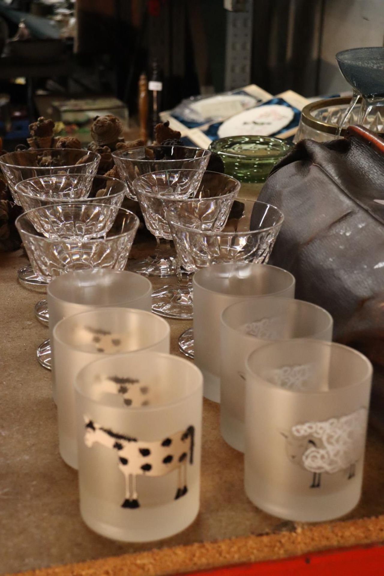 SIX GLASS SUNDAE DISHES TOGETHER WITH SIX DRINKING GLASSES ETCHED WITH ANIMALS