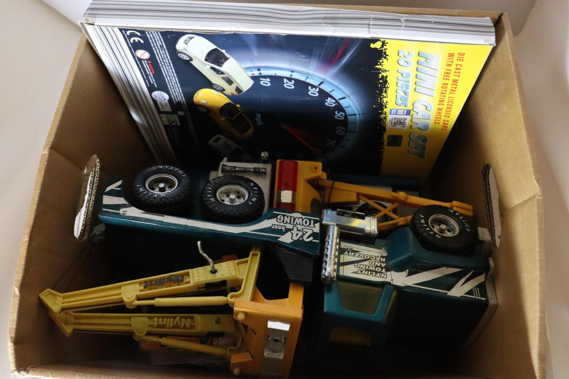 TWO LARGE TOY WRECKER TRUCKS, A TOY SCANIA CAR TRANSPORTER AND CARS AND A BOXED WELLY 20 PIECE TOY