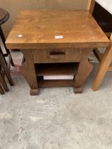 AN OAK MAGAZINE TABLE WITH SINGLE DRAWER