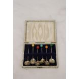 A SET OF SIX HALLMARKED SHEFFIELD SILVER COFFEE BEAN SPOONS WITH VARIOUS COLOURED TOPS IN A