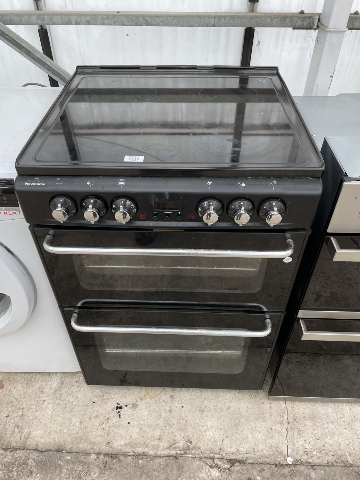 A BLACK NEW WORLD ELECTRIC OVEN AND HOB