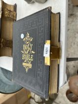 A VINTAGE LEATHER BOUND BIBLE WITH BRASS DETAIL