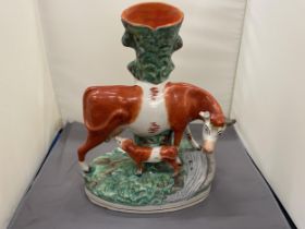 A VINTAGE STAFFORDSHIRE FLATBACK COW AND CALF SPILL HOLDER, HEIGHT 30CM