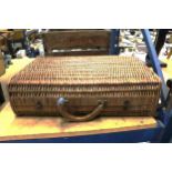 A VINTAGE WICKER TRAVELLING CASE WITH STICKERS, HANDLE A/F