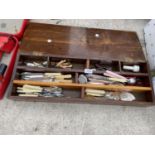 A WOODEN BOX CONTAINING AN ASSORTMENT OF FLATWARE