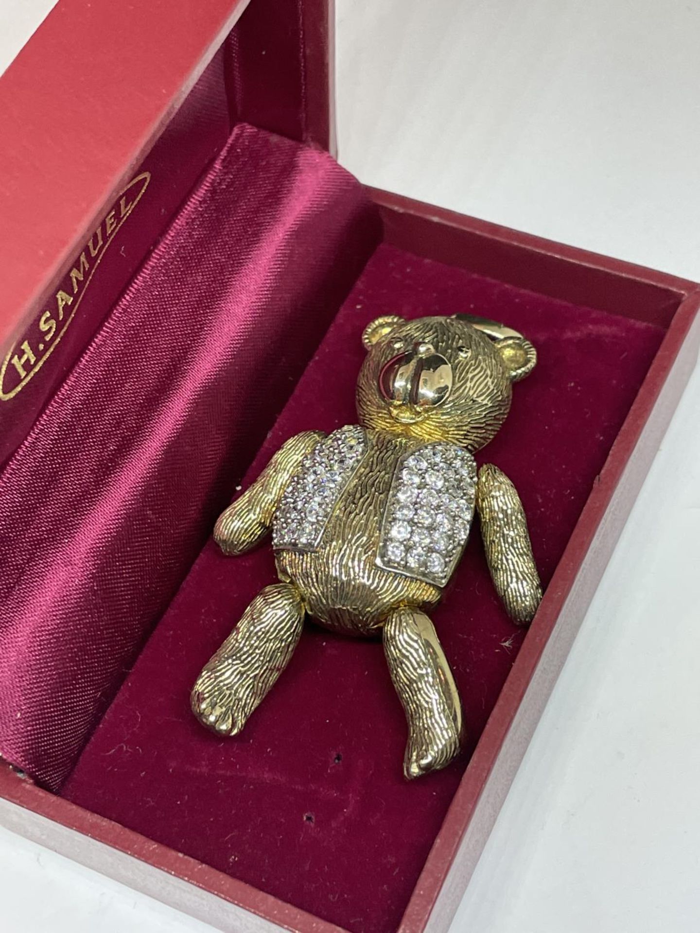 A SWAROVSKI SILVER GILT AND CRYSTAL TEDDY IN A PRESENTATION BOX