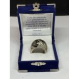 A SILVER RING WITH CUBIC ZIRCONIAS IN A PRESENTATION BOX