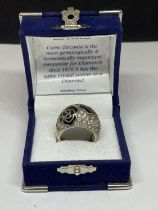 A SILVER RING WITH CUBIC ZIRCONIAS IN A PRESENTATION BOX