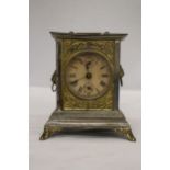 AN ORNATE VINTAGE ALARM CARRIAGE CLOCK WITH LION HANDLE DECORATION TO THE SIDES - POSSIBLY AN