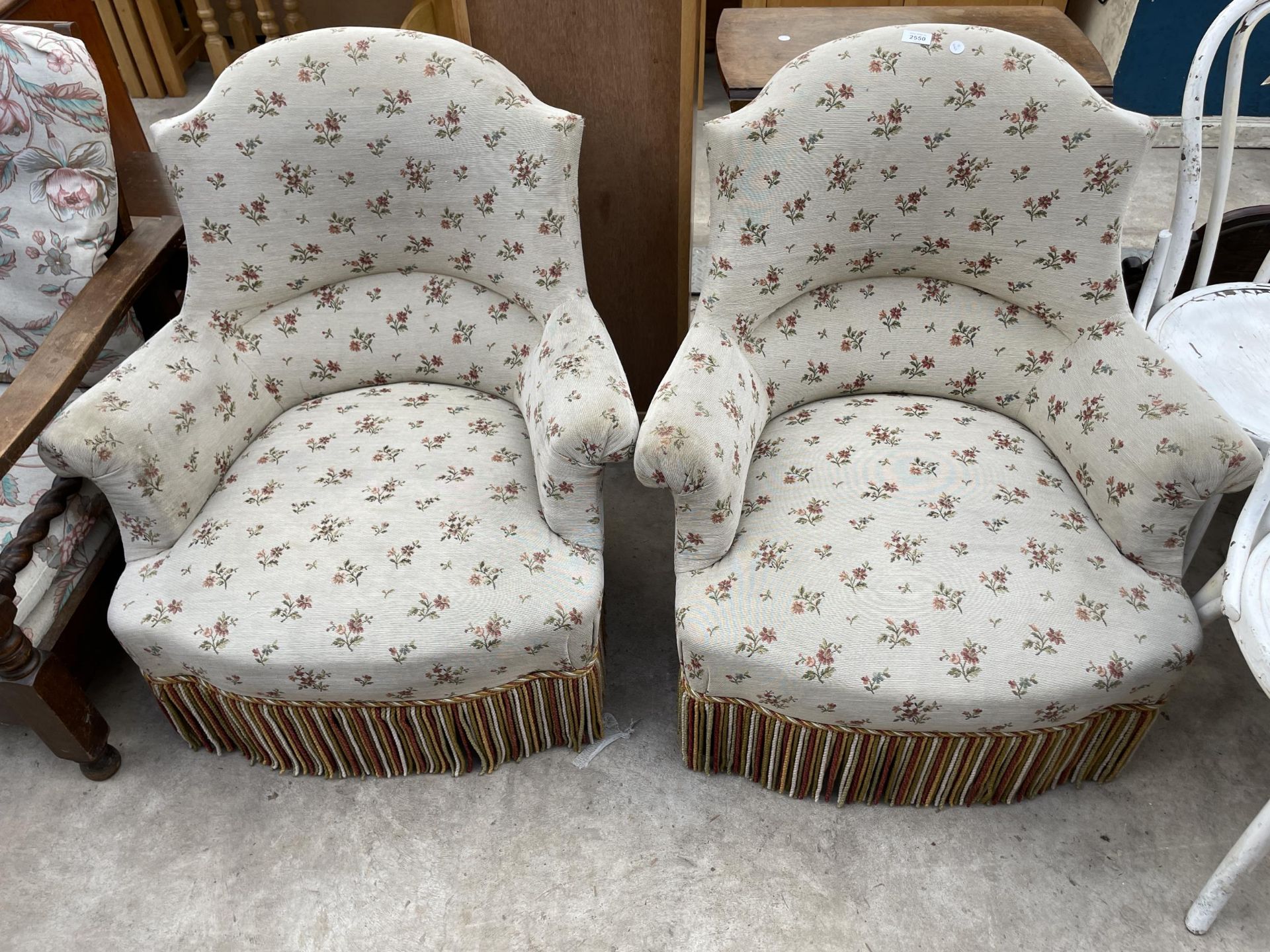 A PAIR OF LATE VICTORIAN SPRUNG AND UPHOLSTERED EASY CHAIRS