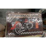 A TIN BUSTED KNUCKLE GARAGE SIGN