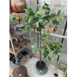 AN ARTIFICIAL ORANGE TREE WITH A DECORATIVE BRASS PLANTER