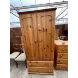 A PINE TWO DOOR WARDROBE WITH TWO DRAWERS TO BASE