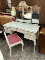 A CREAM AND GILT DRESSING TABLE WITH SIMILAR DRESSING STOOL