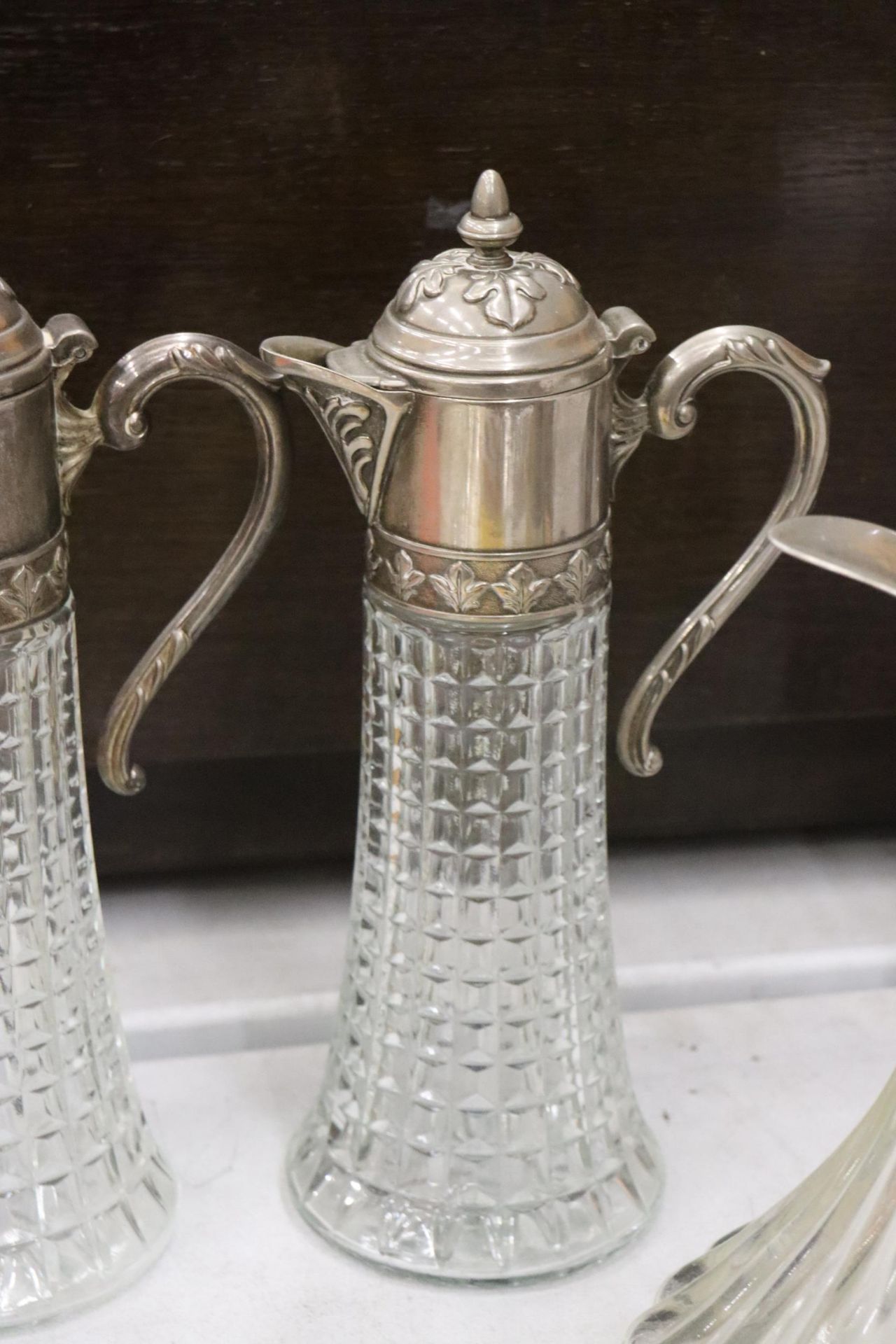 TWO VINTAGE CLARET JUGS WITH SILVER PLATED TOPS PLUS A BELL BOTTOM DECANTER MISSING FINIAL - Image 7 of 8