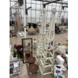 TWO WOODEN OBELISK FRAMES, TWO WOODEN STOOLS AND A FRAMED MIRROR