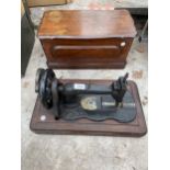 A VINTAGE SEWING MACHINE WITH WOODEN CARRY CASE