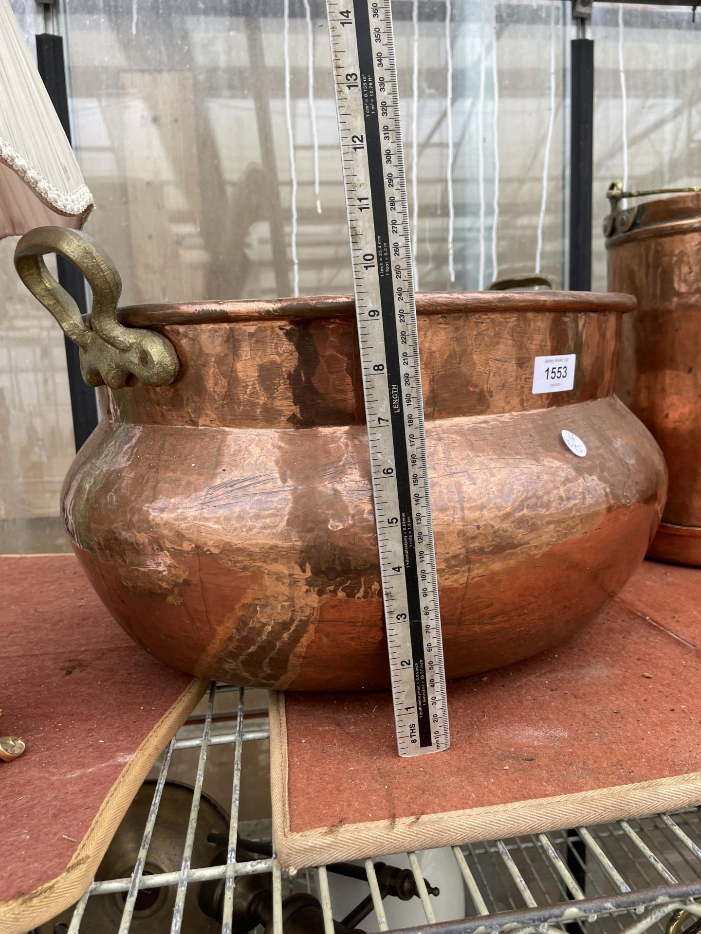 A LARGE VINTAGE COPPER BOWL PLANTER WITH TWIN HANDLES