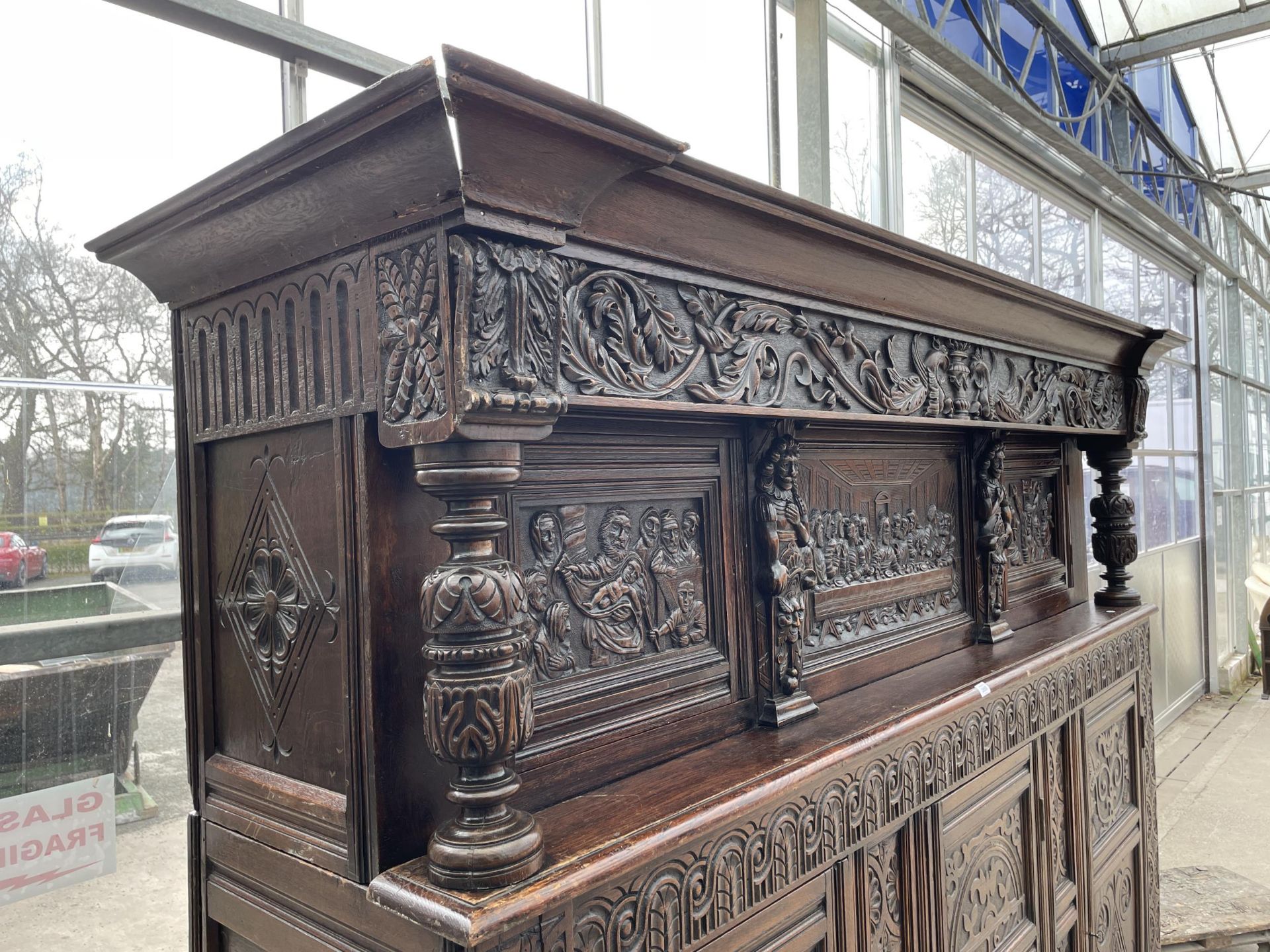 AN OAK GEORGE III STYLE COURT CUPBOARD WITH CARVED PANELS, THREE DEPICTING THE BIRTH AND CRUCIFIXION - Image 3 of 12