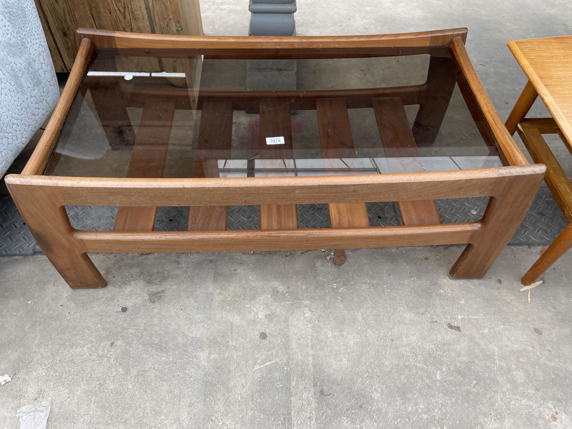 A RETRO TEAK G PLAN STYLE COFFEE TABLE WITH GLASS TOP AND MAGAZINE SHELF 39" X 21"