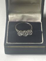 AN 18 CARAT WHITE GOLD TRILOGY RING WITH DIAMONDS TO INCLUDE APPROXIMATELY A CENTRE 0.75 CARAT
