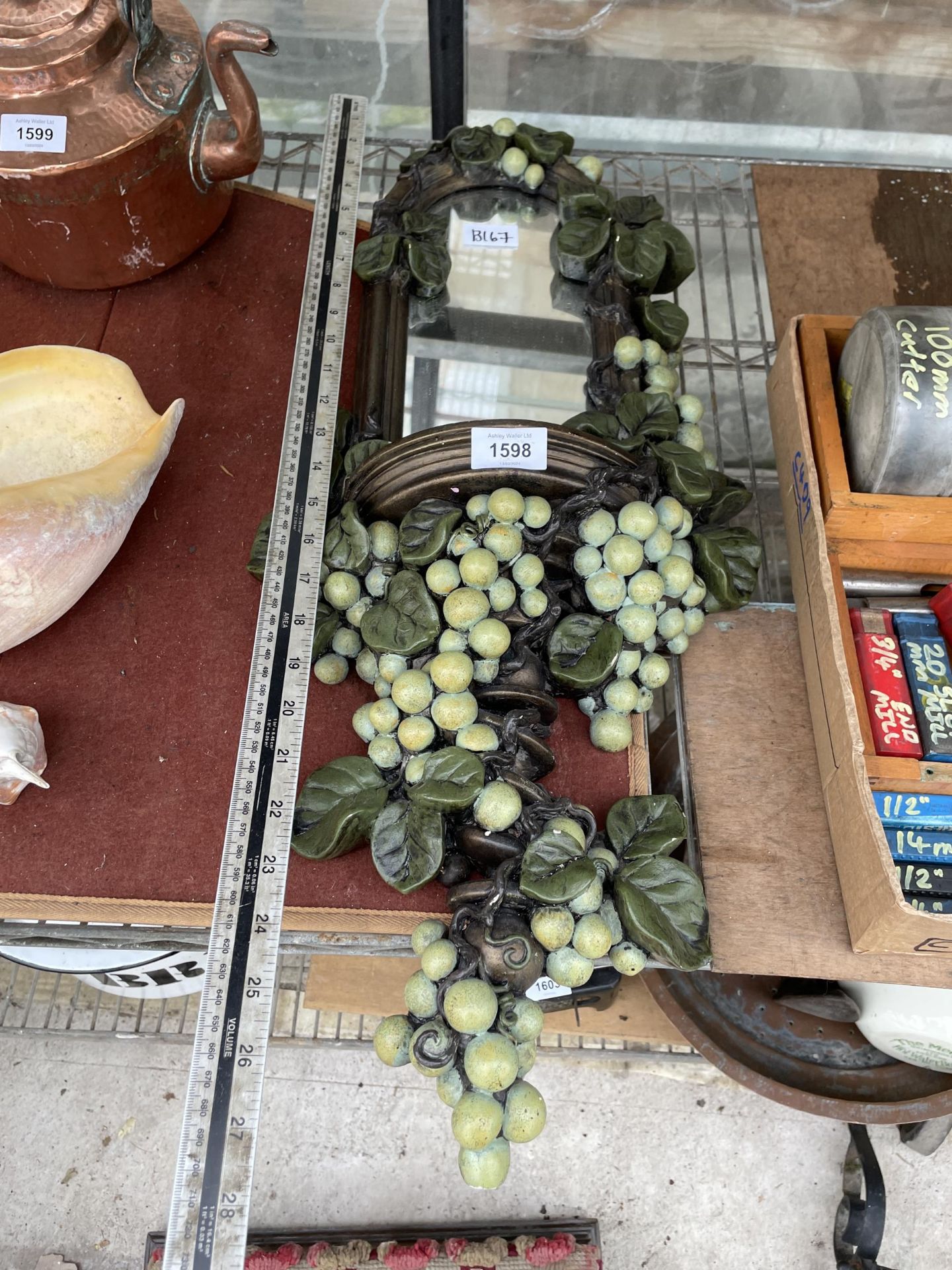 A VINTAGE AND DECORATIVE GRAPE VINE MIRROR