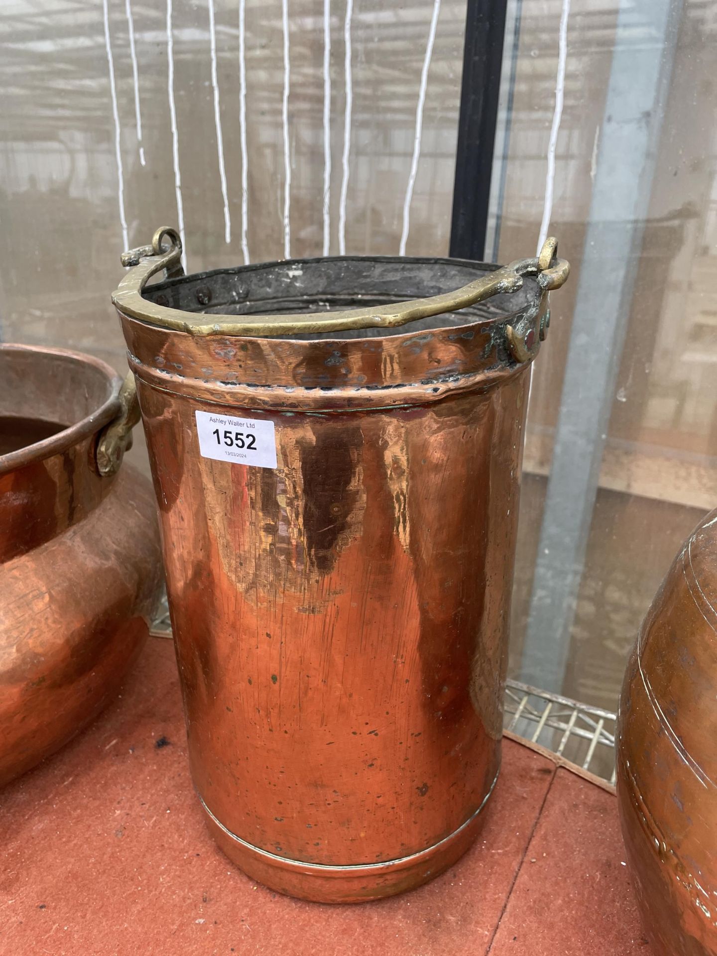 A VINTAGE COPPER STICK STAND WITH BRASS HANDLE