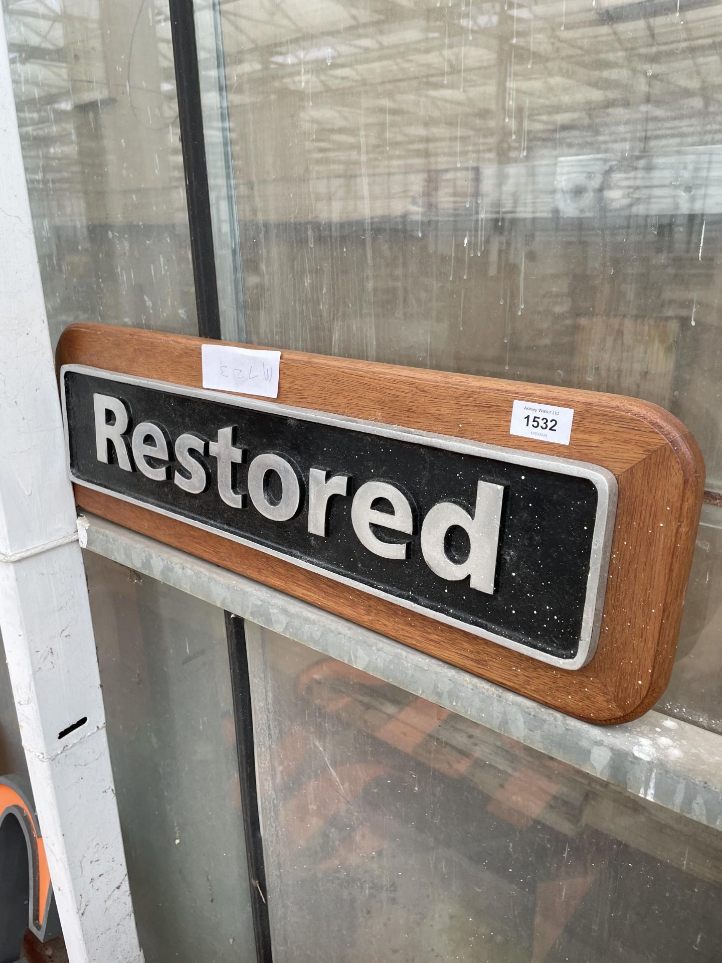 A METAL 'RESTORED' SIGN WITH WOODEN PLINTH BACKING