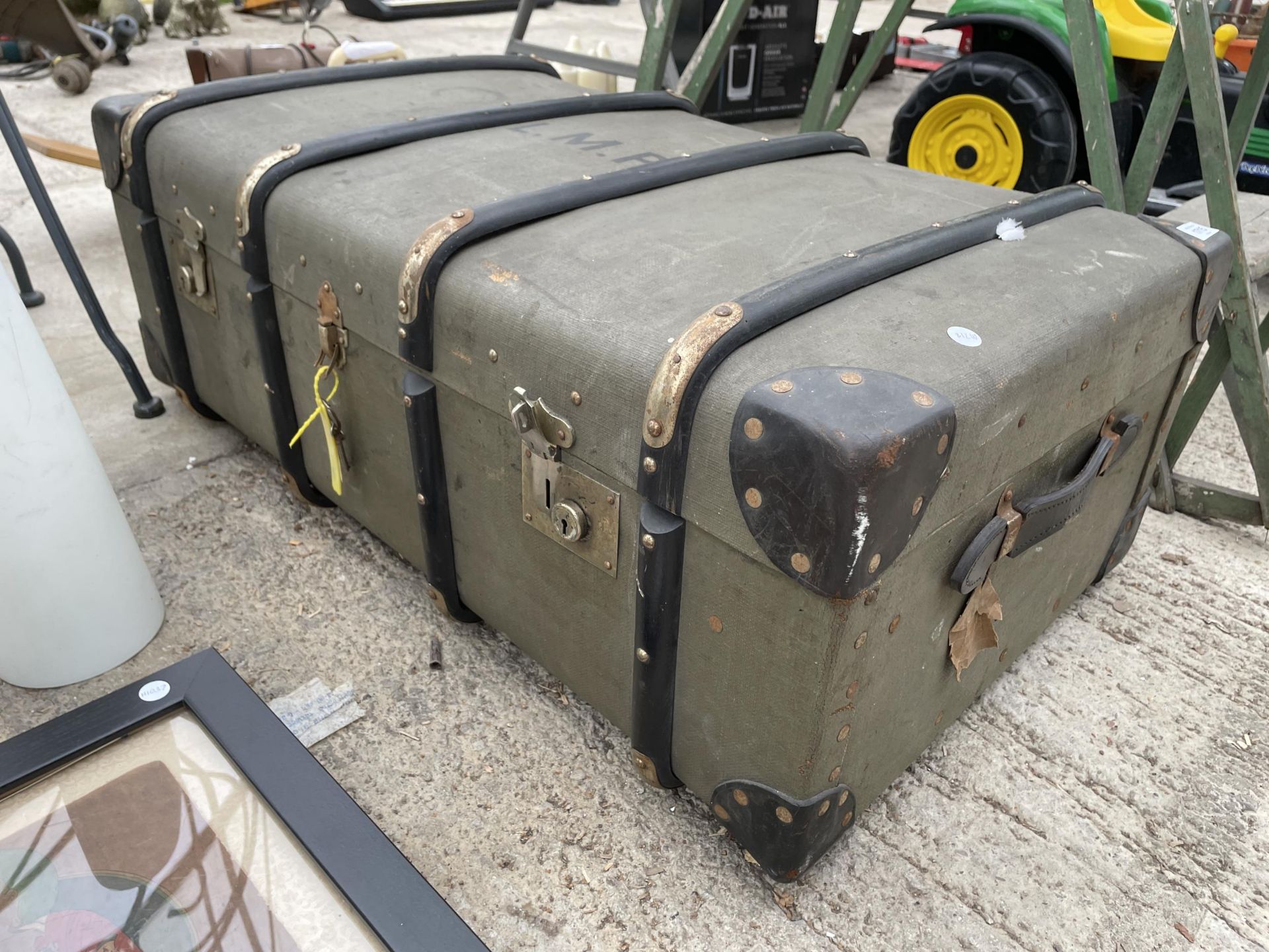 A VINTAGE COMPRESSED FIBRE TRAVEL TRUNK BEARING THE INITIALS L.M.P