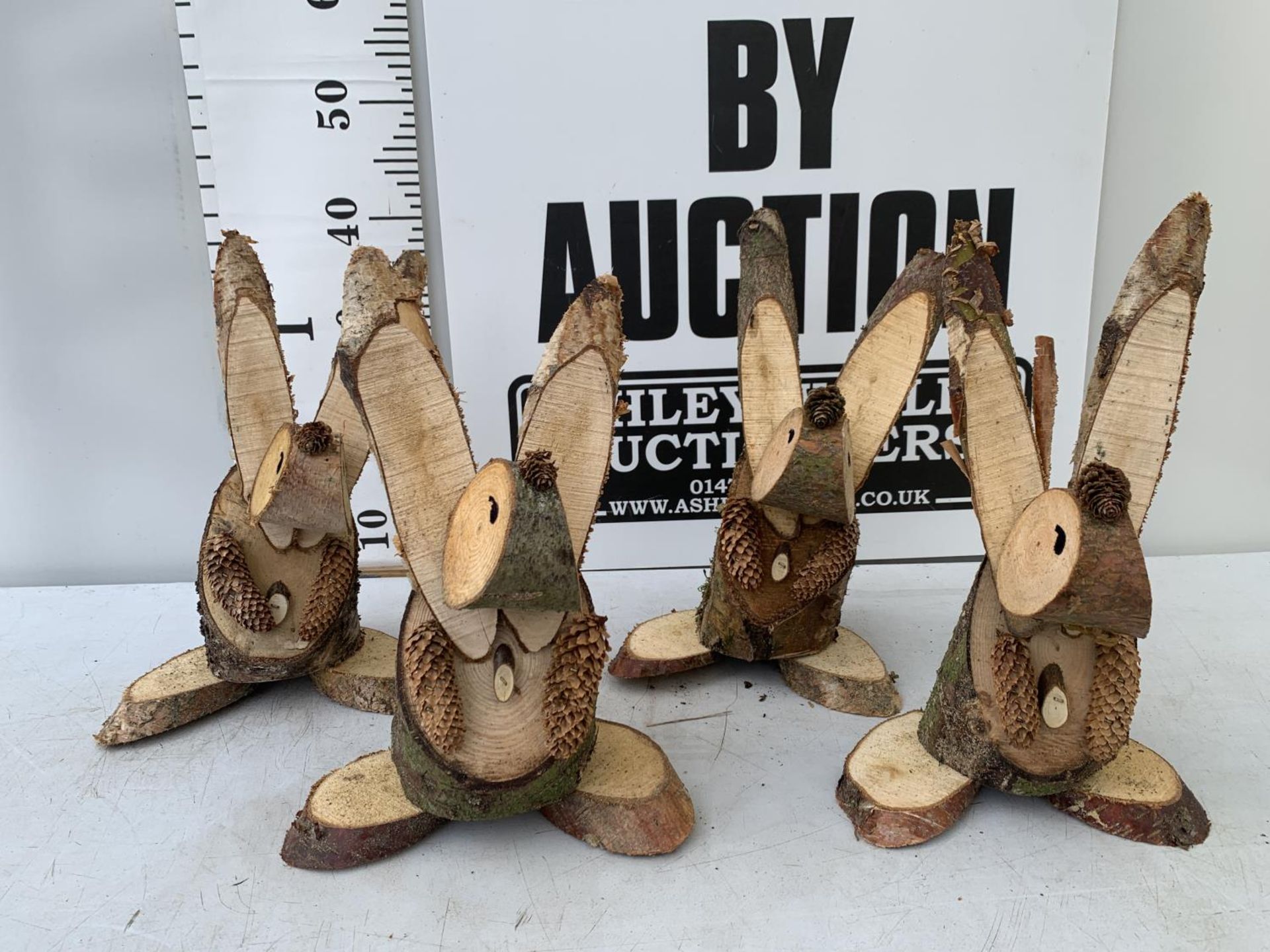 FOUR RABBIT FIGURES MADE FROM LOGS NO VAT TO BE SOLD FOR THE FOUR
