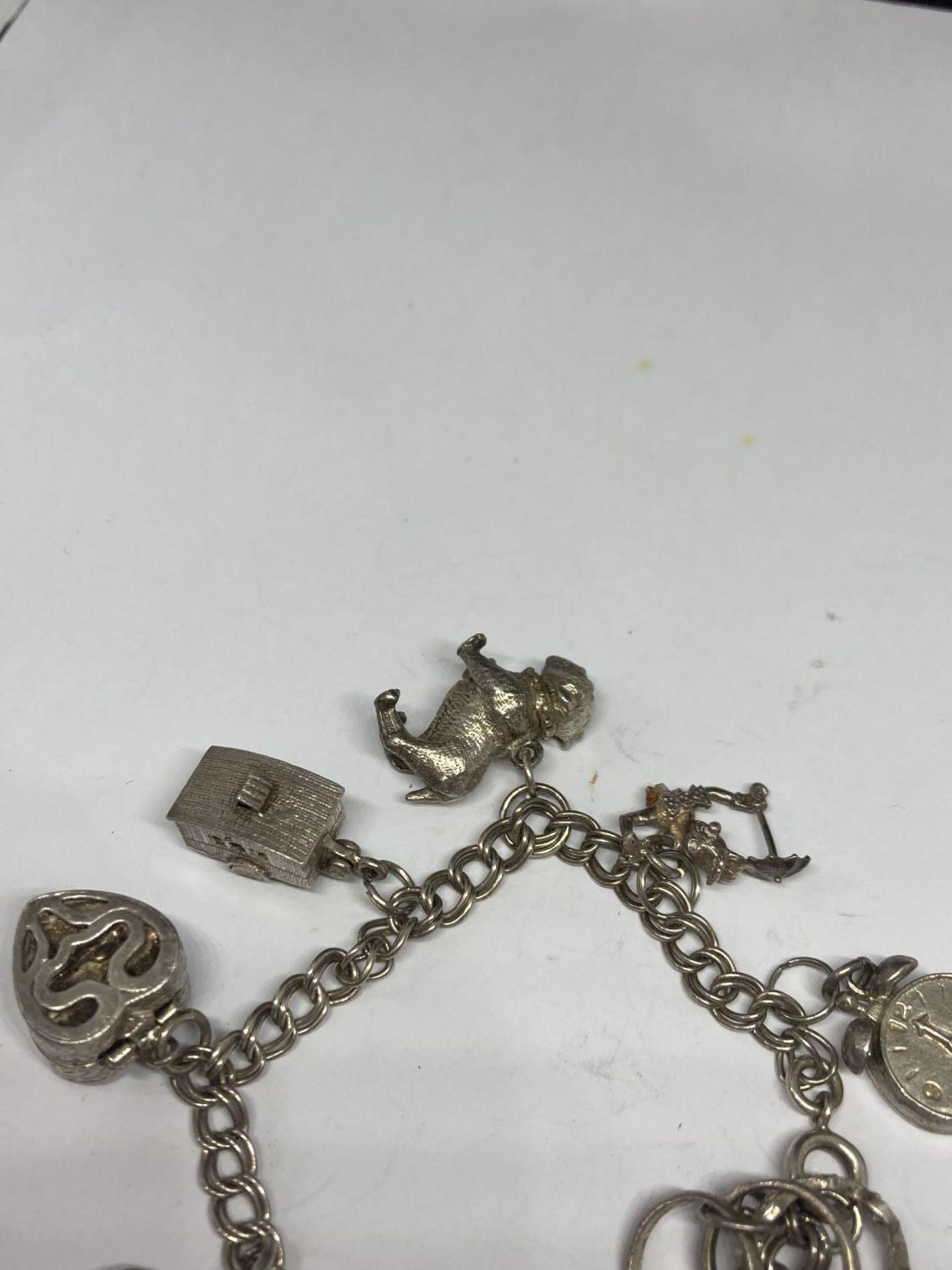 A SILVER CHARM BRACELET WITH TEN CHARMS - Image 4 of 4