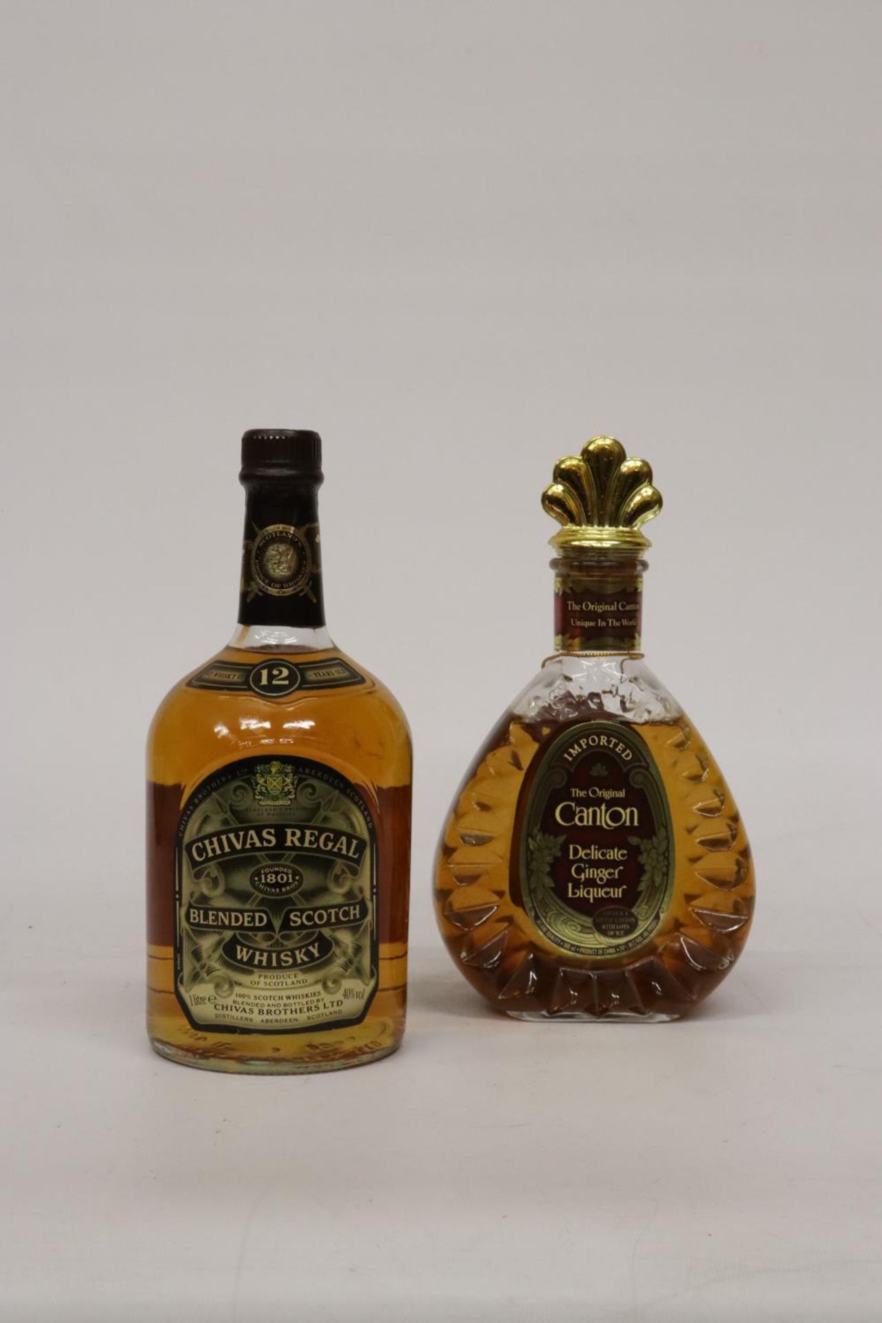 A 1L BOTTLE OF CHIVAS SCOTCH WHISKEY AND A 50CL BOTTLE OF CANTON GINGER LIQUEUR