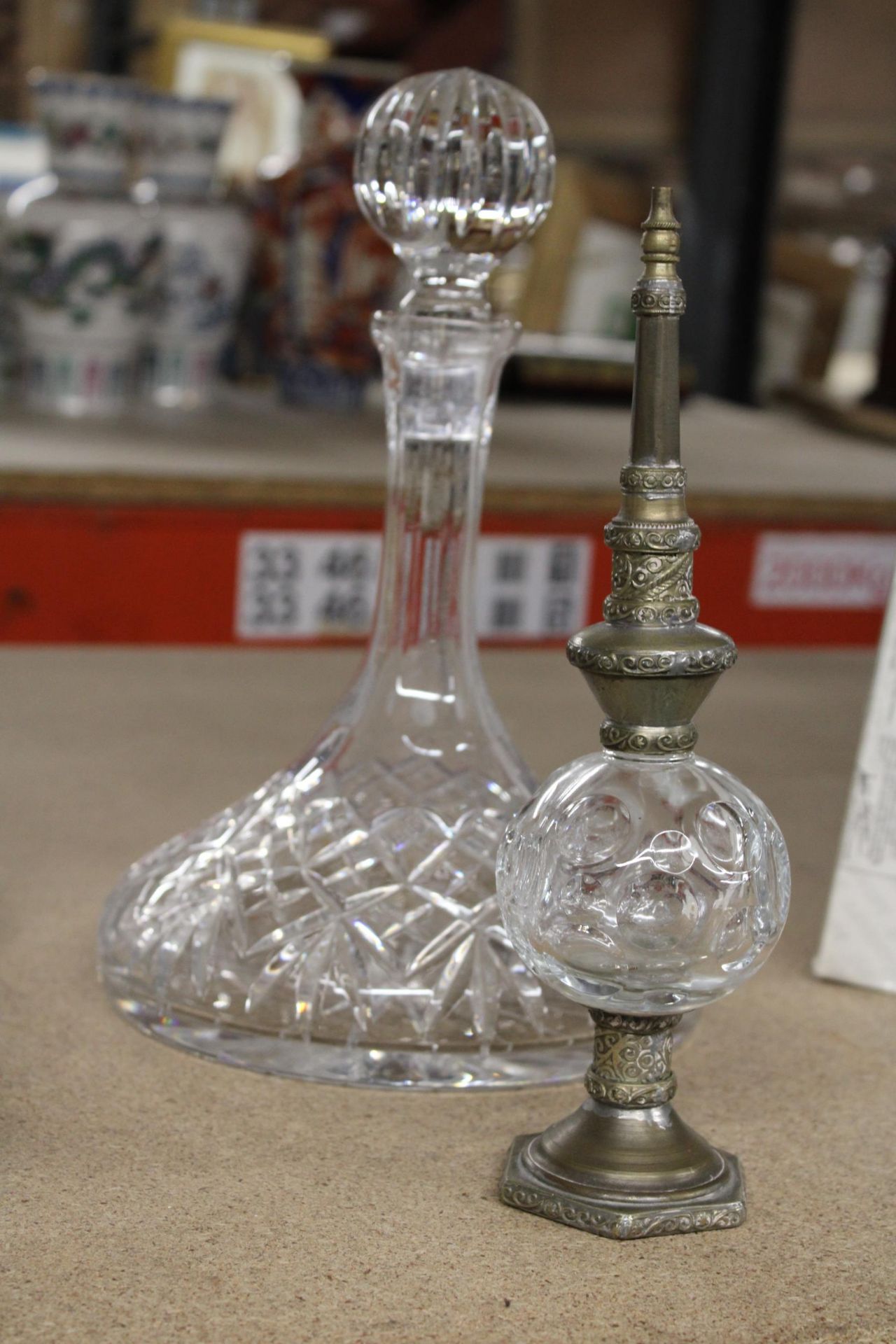 A CUT GLASS SHIPS DECANTER AND A MOROCCAN SCENT BOTTLE