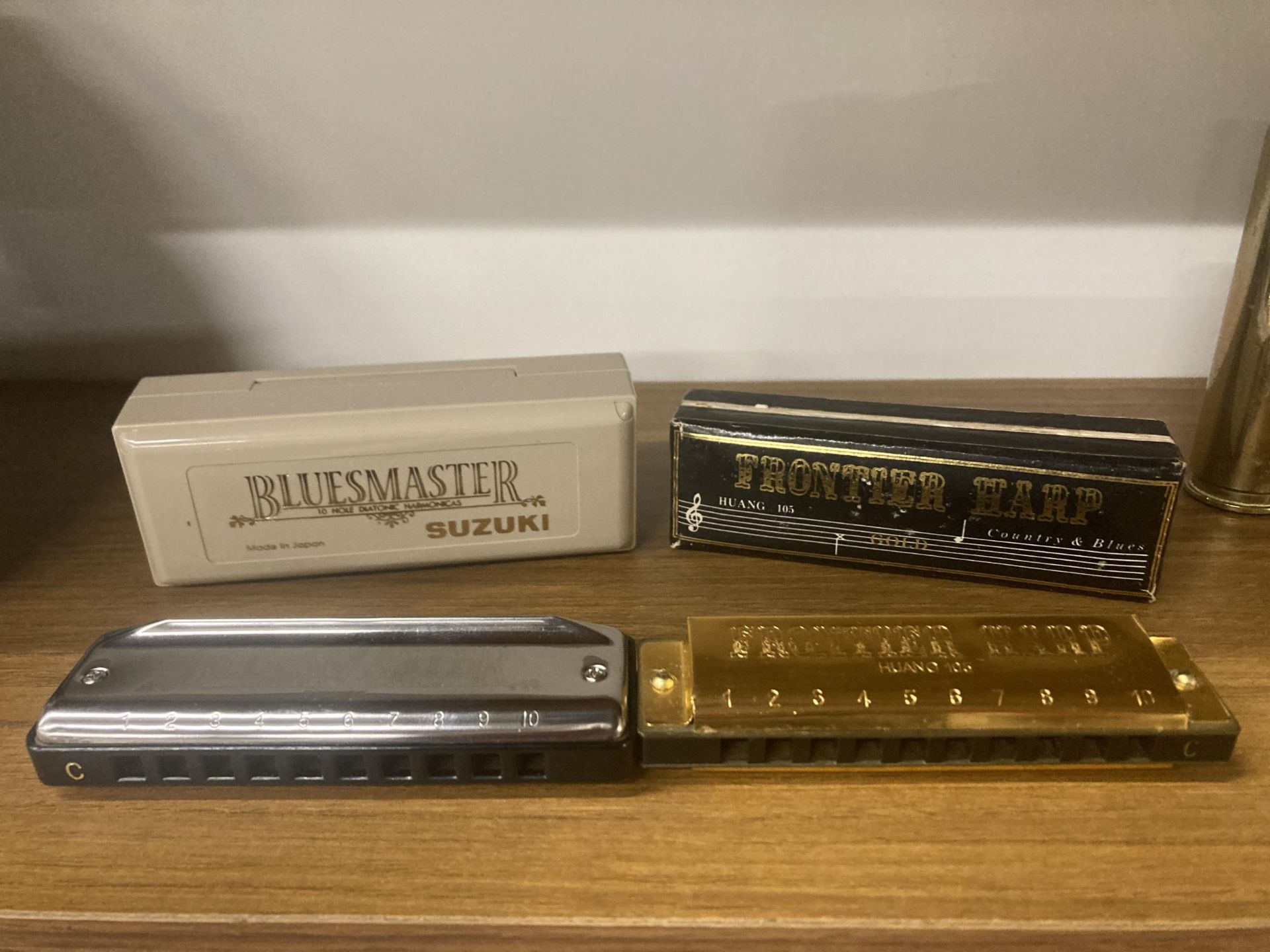 TWO HARMONICAS TO INCLUDE A SUZUKI BLUESMASTER IN KEY 'C' AND A FRONTIER HARP HARMONICA GOLD
