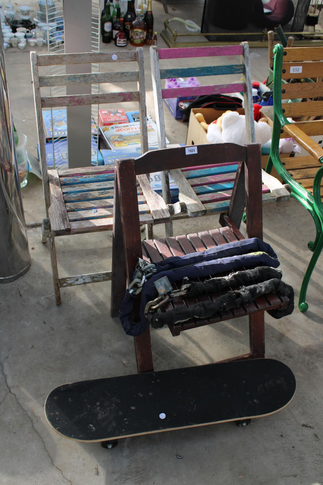 THREE WOODEN FOLDING CHAIRS, A SKATEBOARD AND TWO CHAINS AND PADLOCKS ETC