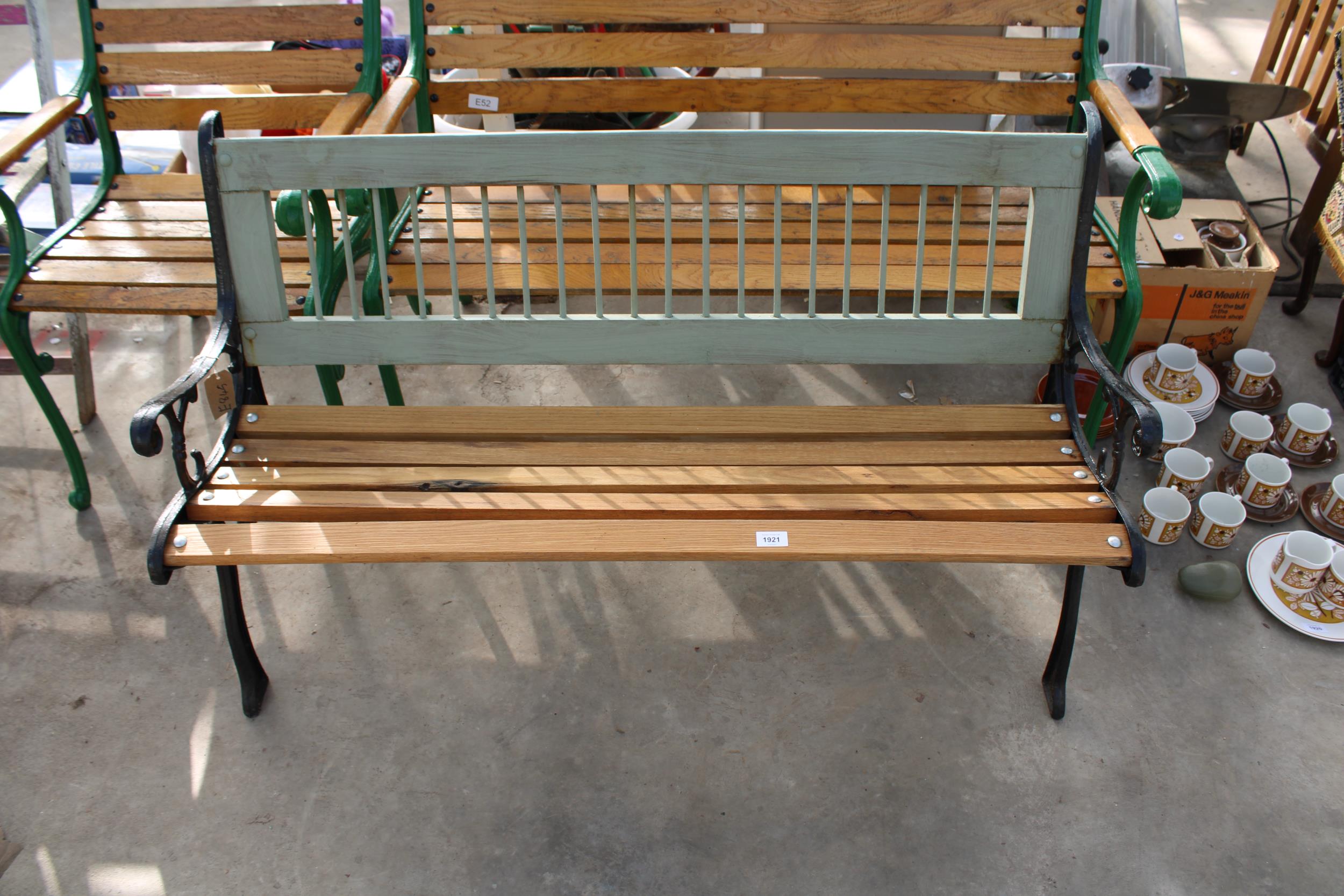 A WOODEN SLATTED GARDEN BENCH WITH DECORATIVE CAST BENCH ENDS - Image 2 of 2