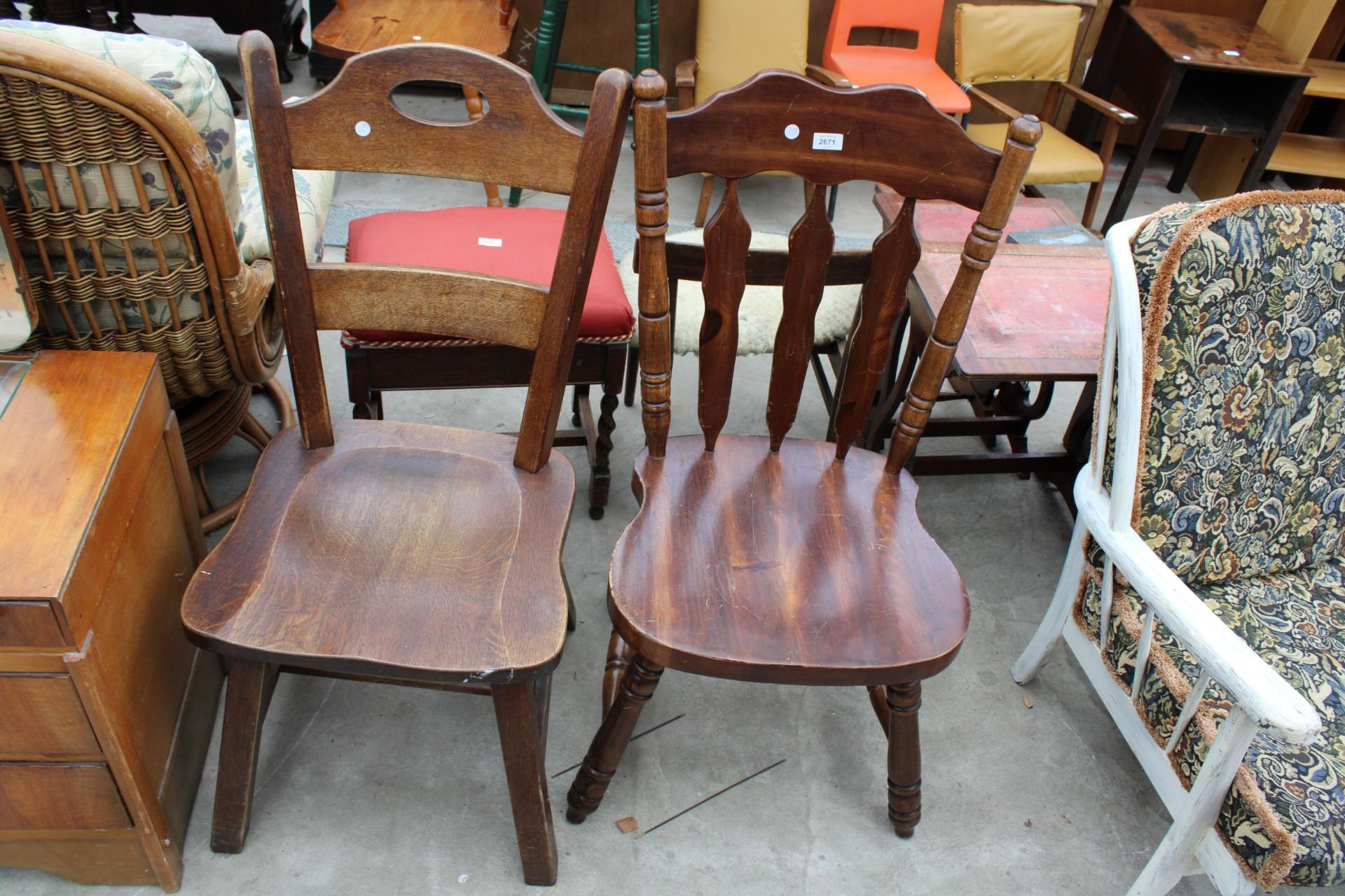 A MID TWENTIETH CENTURY OAK LADDER BACK CHAIR AND HARDWOOD KITCHEN CHAIR