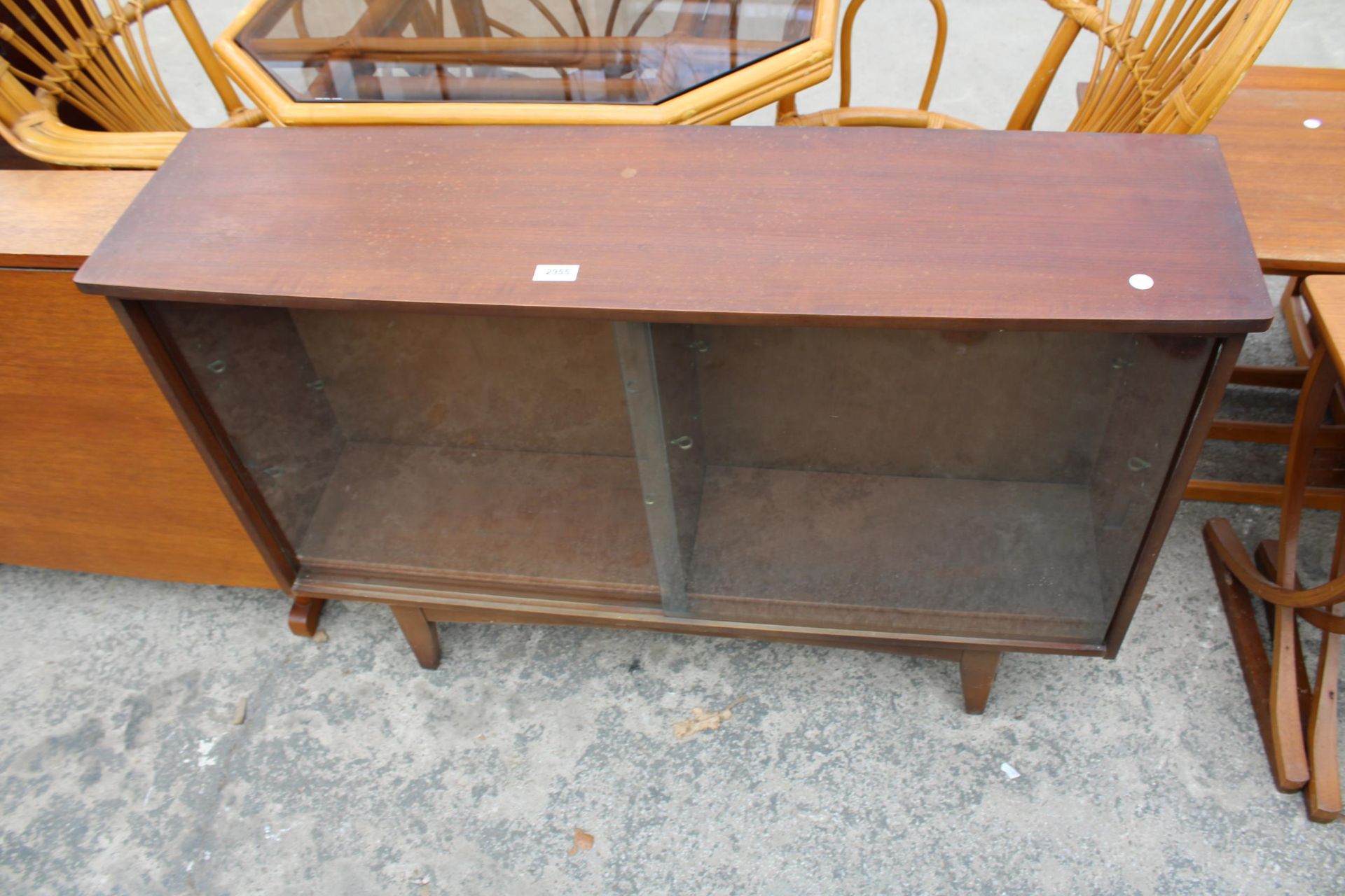 A RETRO TEAK BOOKCASE WITH TWO SLIDING GLASS DOORS 43" WIDE