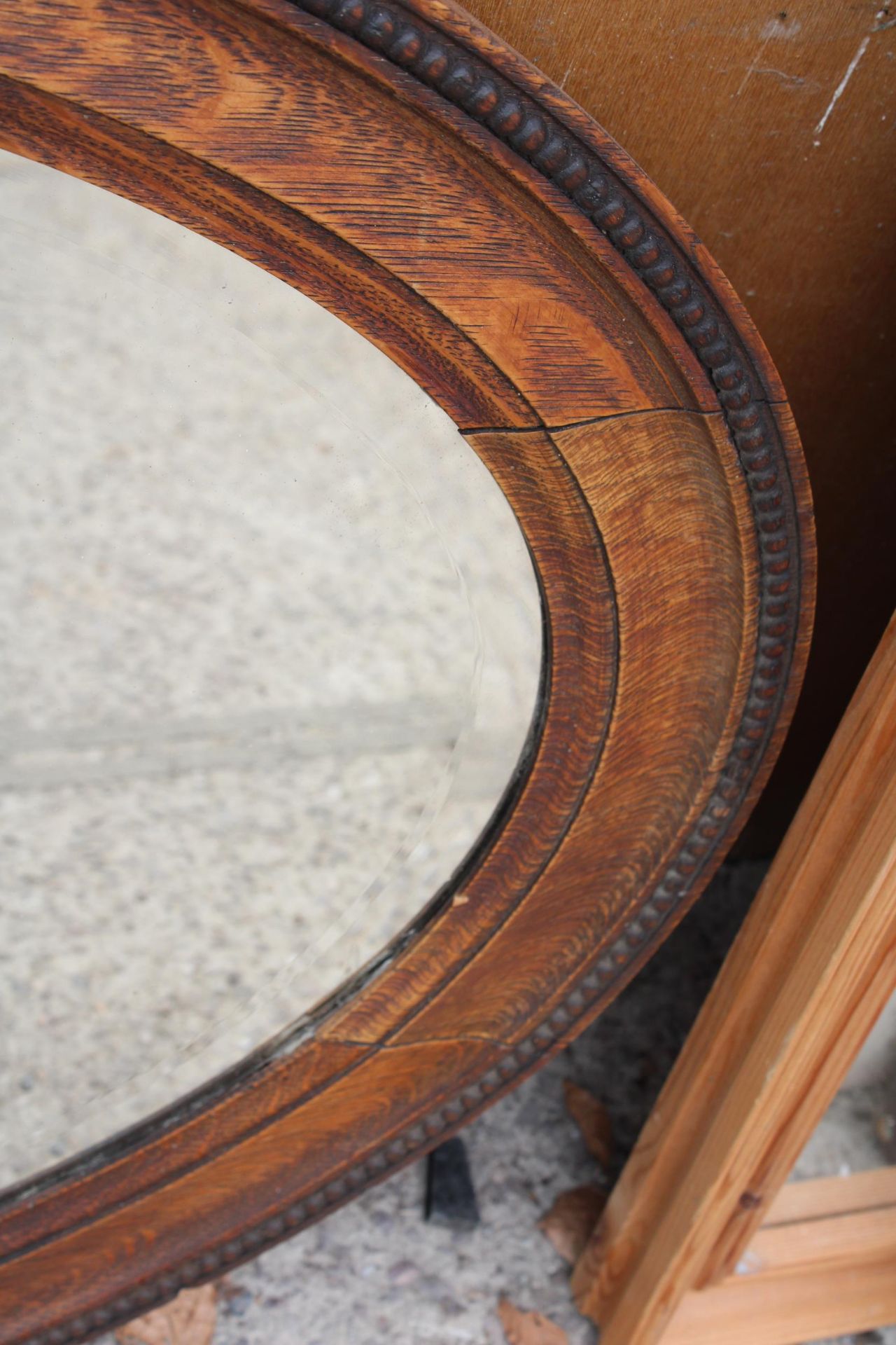 A MID 20TH CENTURY OVAL OAK BEVEL EDGED MIRROR 34" X 24" - Image 3 of 3