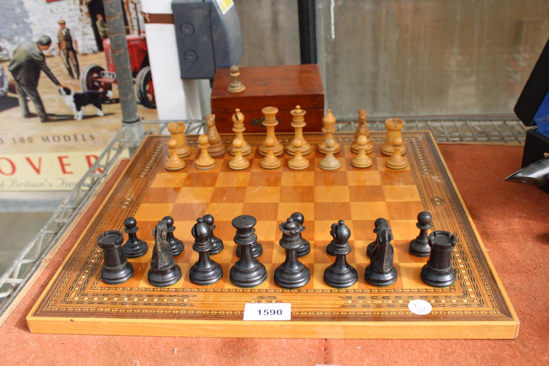 A VINTAGE CHESS BOARD WITH A CHESS SET (ONE PIECE IS A REPLACEMENT)