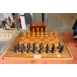 A VINTAGE CHESS BOARD WITH A CHESS SET (ONE PIECE IS A REPLACEMENT)