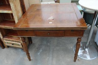 A MID 20TH CENTURY OAK AND BEECH DRAW LEAF DINING TABLE