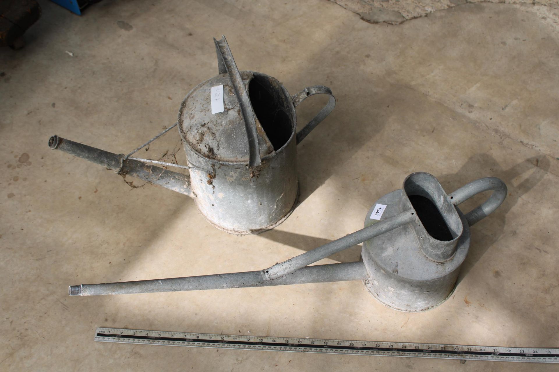 A VINTAGE GALVANISED LONG SPOUTED HAWES WATERING CAN AND A FURTHER GALVANISED WATERING CAN