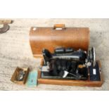 A VINTAGE SINGER SEWING MACHINE WITH WOODEN CARRY CASE, MANUAL AND SPARE PARTS ETC